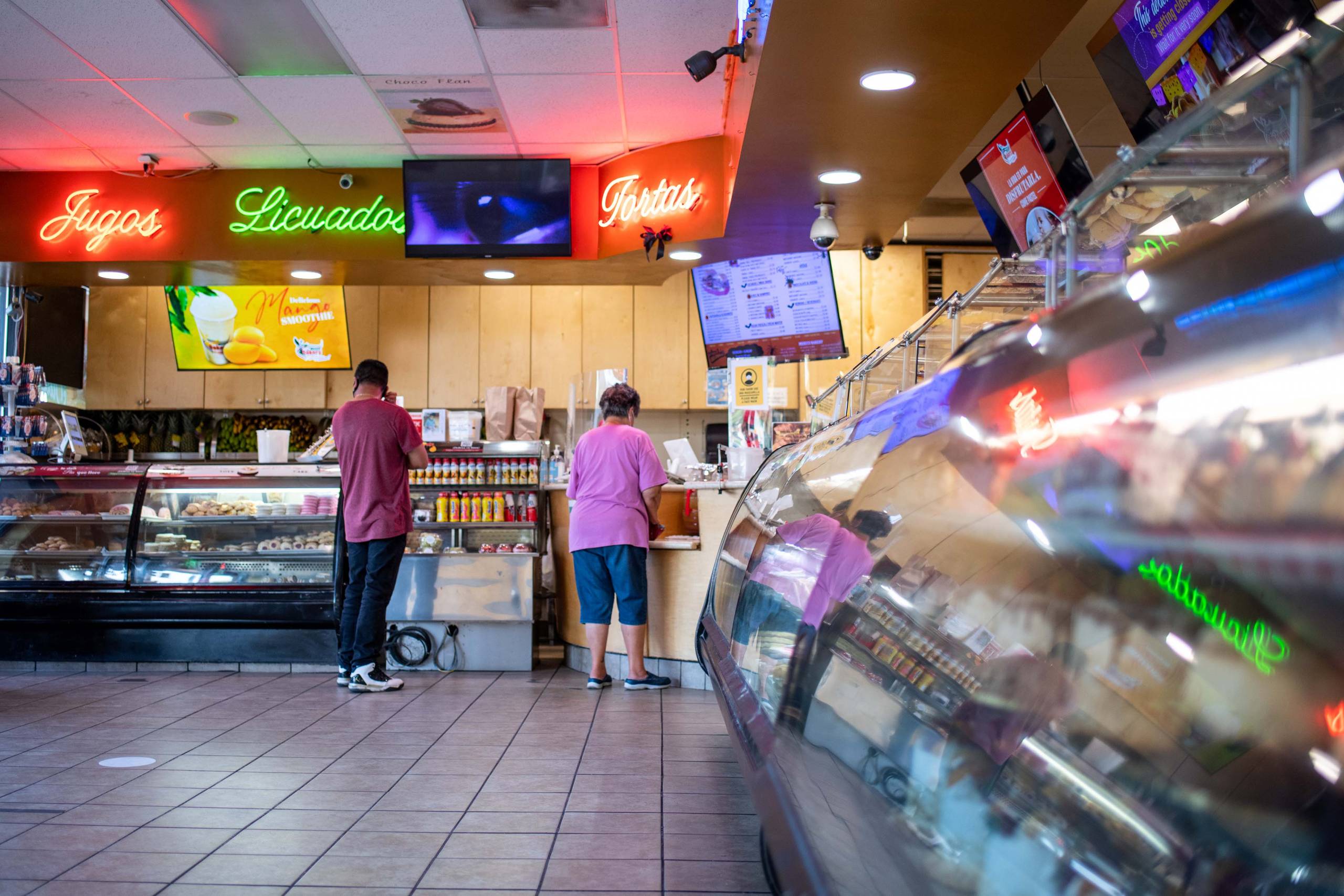 Interior of a Mexican bakery, with a display of cakes visible to the side.