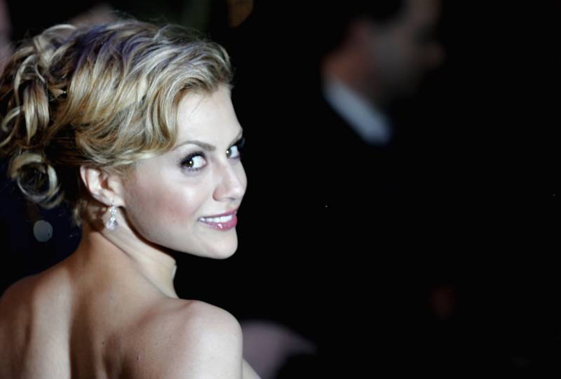 The actress, Brittany Murphy, glances over her shoulder and smiles for the camera.