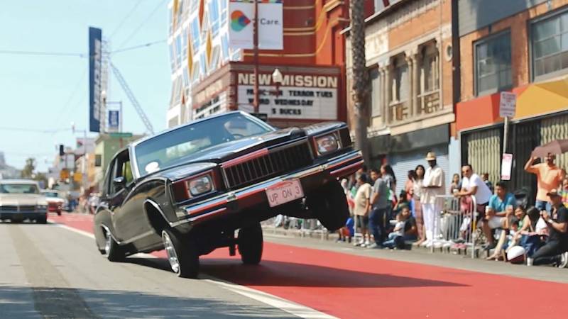 A lowrider rides on three wheels in the Mission District in 2016.