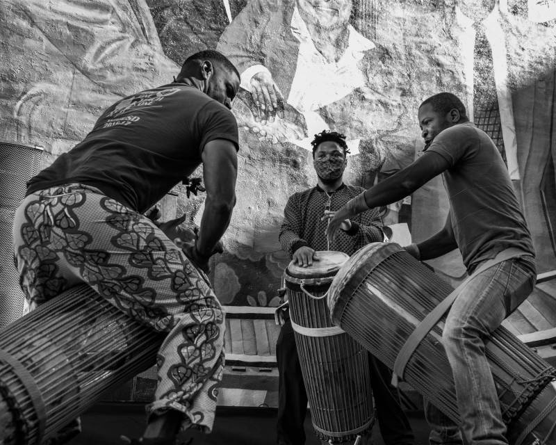 Drummers gather at a celebration for the new mural on 14th Street in Oakland.