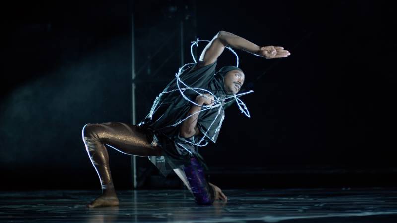Kinetic Light dancer Jerron Herman dances wrapped in barb wire for technical rehearsals of “Wired.”