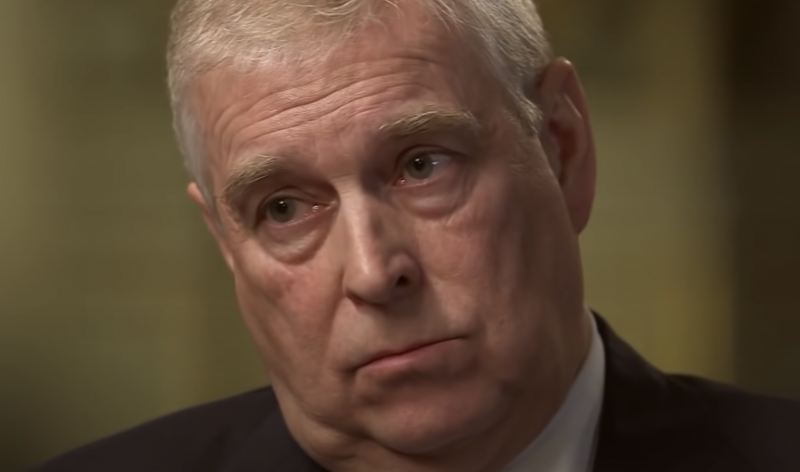 A close-up of Prince Andrew's face, tilted to one side and looking browbeaten.