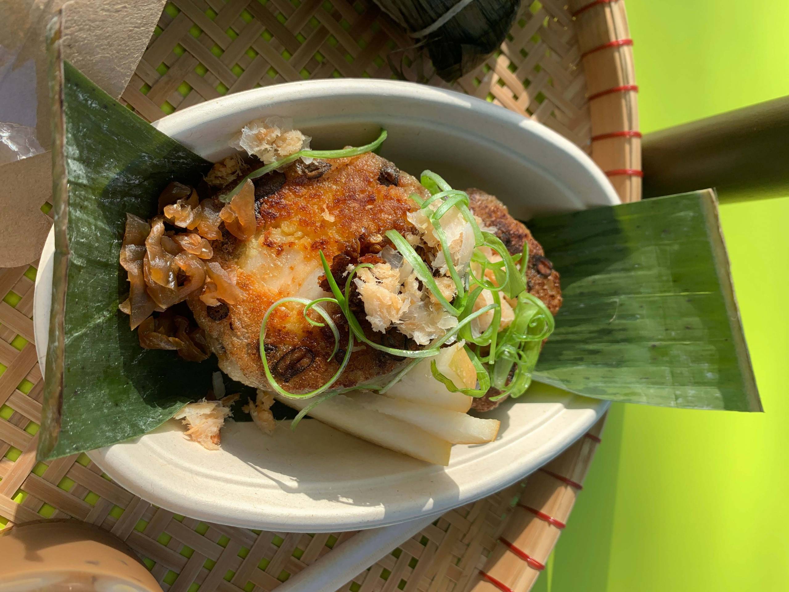 Overhead view of banh tet, a kind of savory rice cake served on top of a banana leaf.
