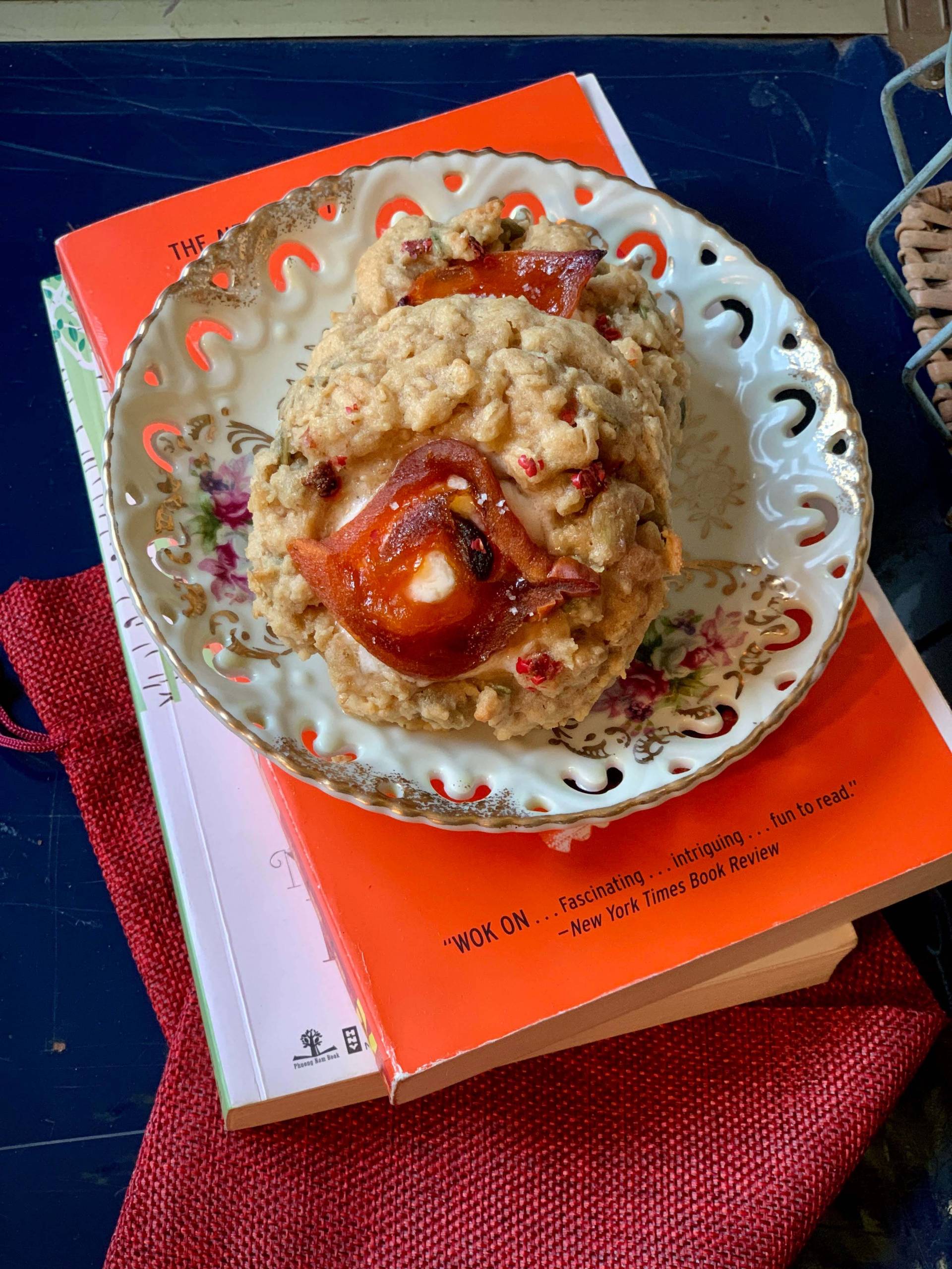 An oatmeal cooking on a plate, on top of a stack of books.