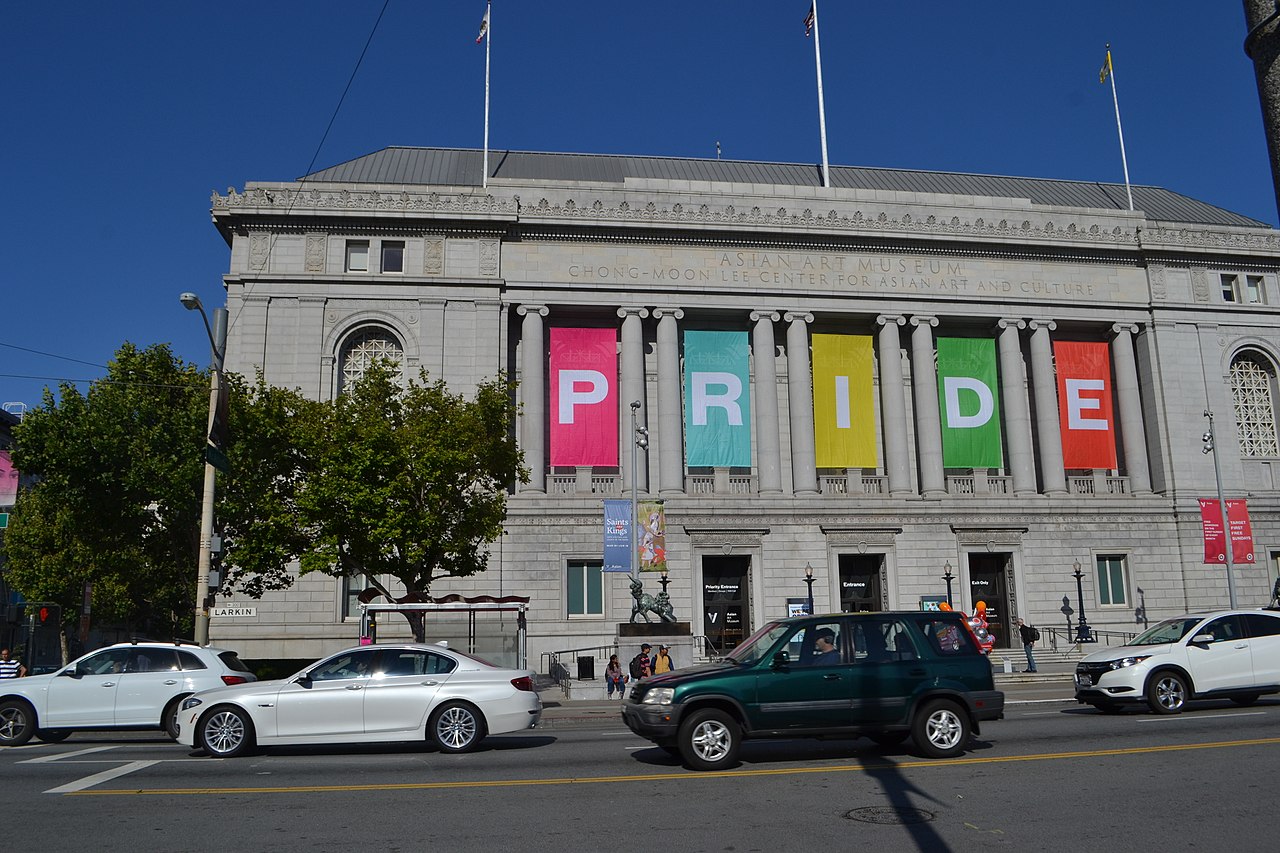 Building exterior with colorful flags spelling "PRIDE"