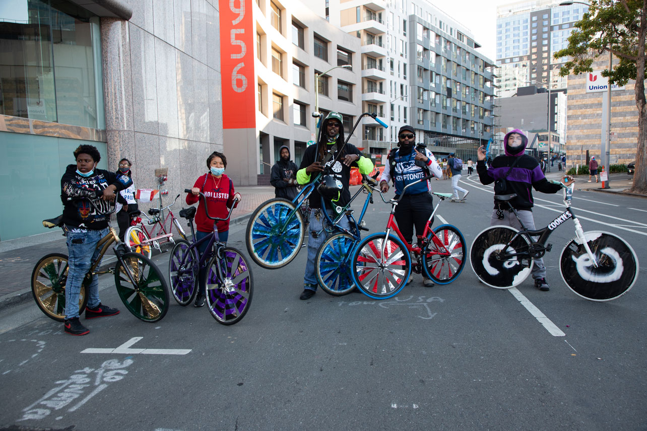 A group poses with their scraper bikes