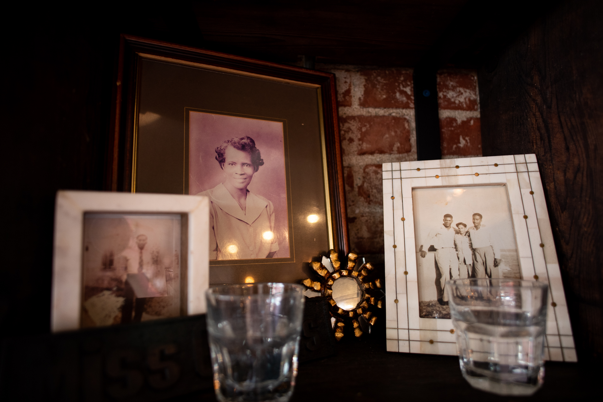 A shrine with black-and-white photos of chef Sarah Kirnon's grandmother, Miss Ollie, sits on a shelf.