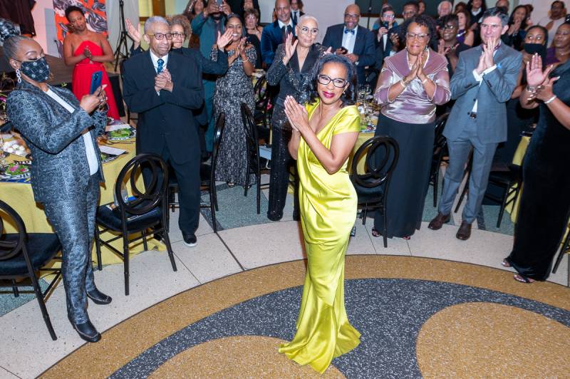 Ms. Regina Jackson receives a standing ovation during her retirement party. 