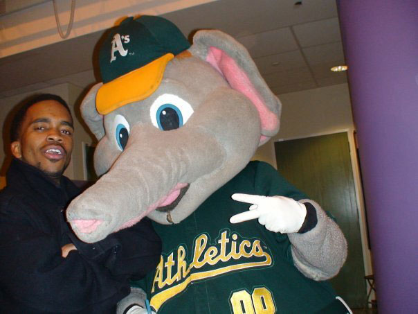 Pen Harshaw with the A's mascot, a giant elephant, poses for the camera