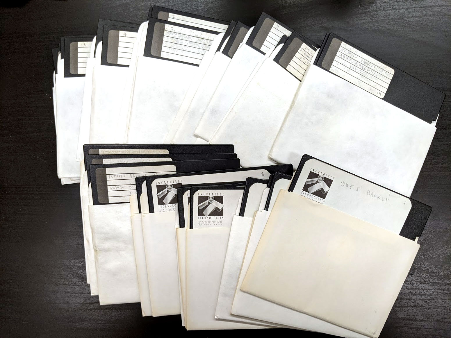 A pile of white-paper wrapped floppy disks