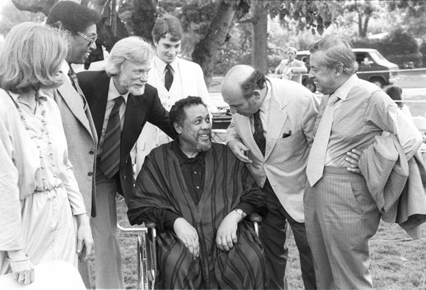 Mingus, in a wheelchair, surrounded by