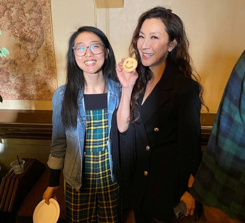 Annie's T Cakes founder Annie Wang poses for a photo with actress Michelle Yeoh, who holds an almond cookie that Wang baked.