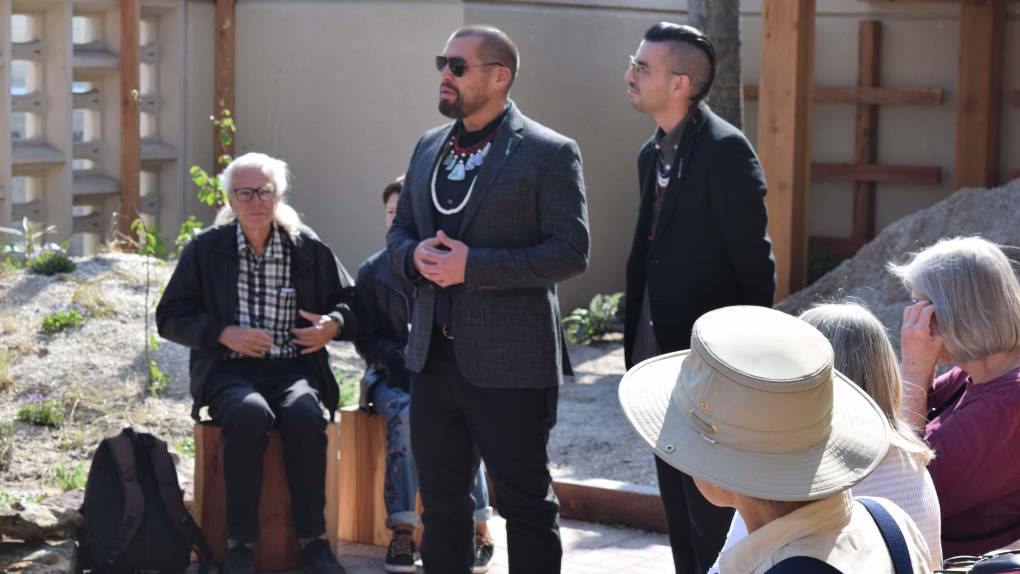 Vincent Medina and Louis Trevino address a group of visitors at a preview event for their restaurant Cafe Ohlone, in the outdoor courtyard of the Hearst Museum.