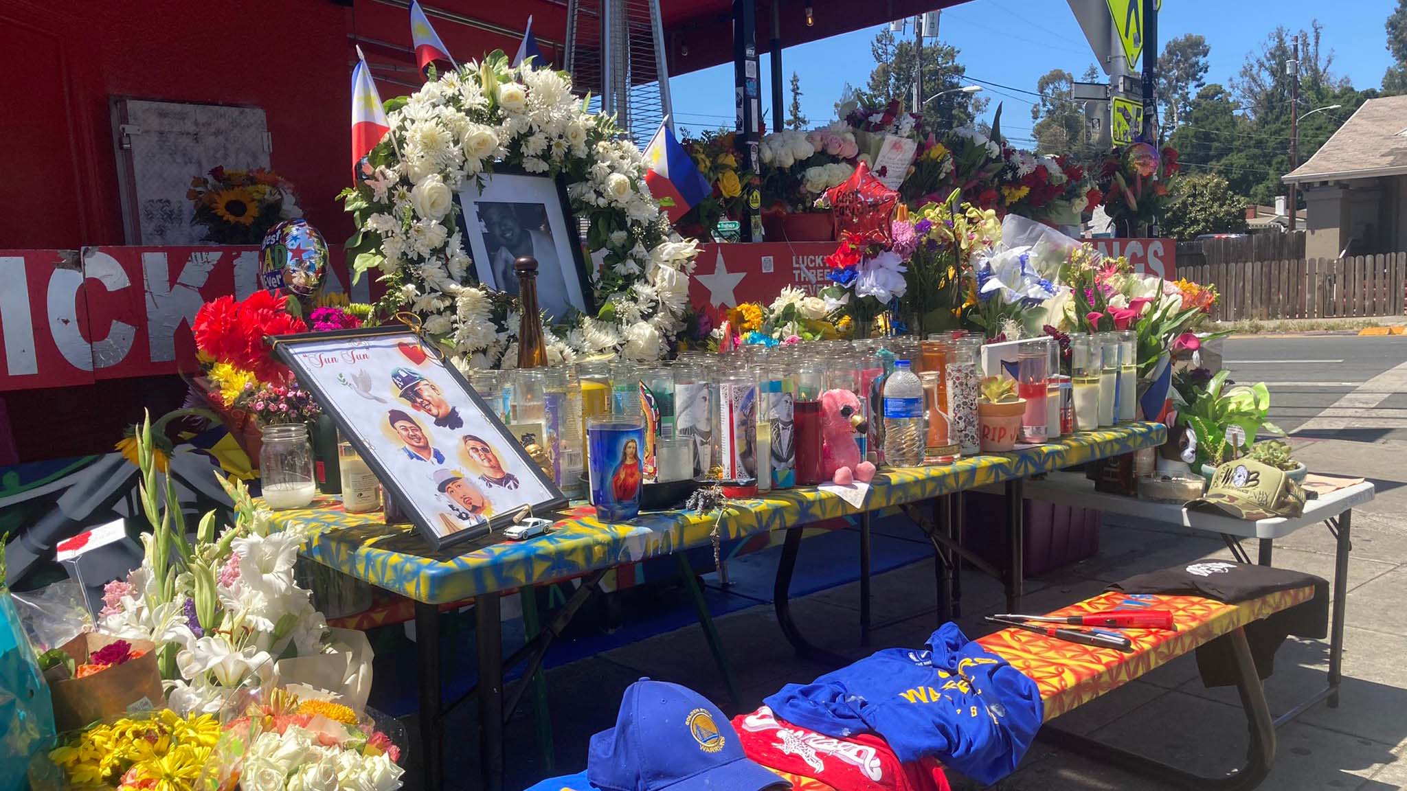 A memorial to Jun Anaba, with flowers, candles and photos, set up outside Lucky Three Seven restaurant.