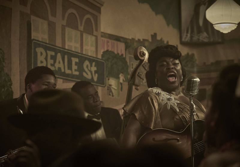 A Black woman portraying gospel singer Sister Rosetta Tharpe in a new film sings into a 1950s-style microphone