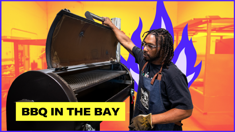 A man in a work apron holds the lid of a barbecue smoker, as stylized blue flames shoot up behind him. Text reads, "BBQ in the Bay."