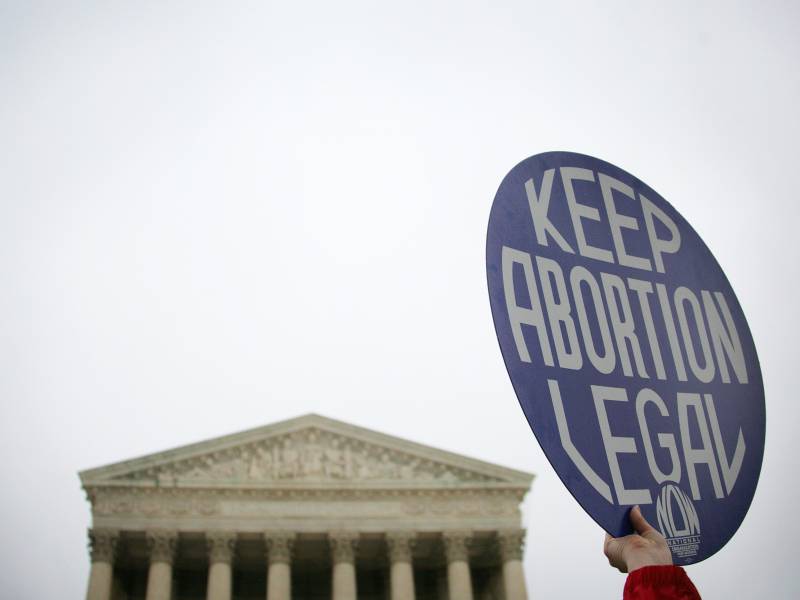 A pro-choice demonstrator holds up a placard outside the US Supreme Court in Washington, DC. The sign reads 'Keep Abortion Legal.'