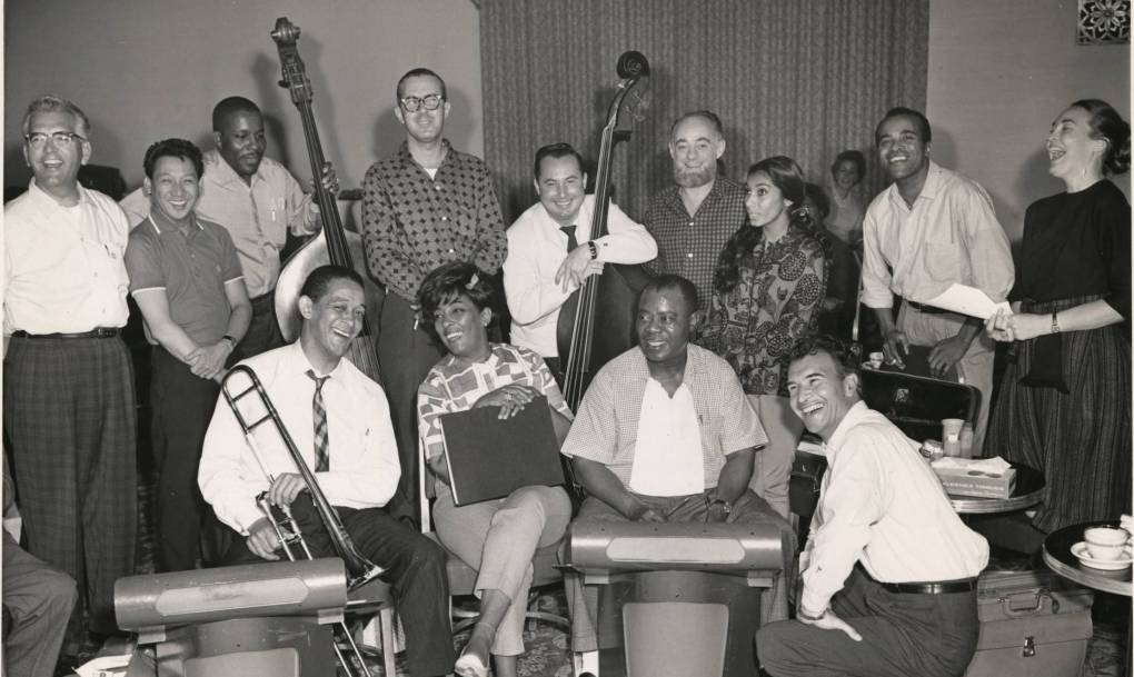 a group of musicians in a black and white photo from the 1960s, practicing for a musical