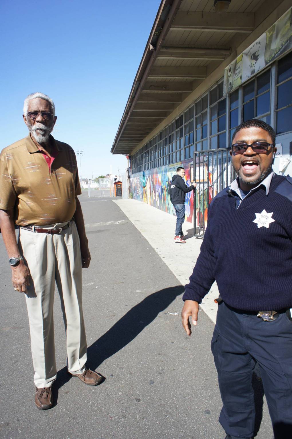 A school security guard and Mr. Bill Russell share a laugh.