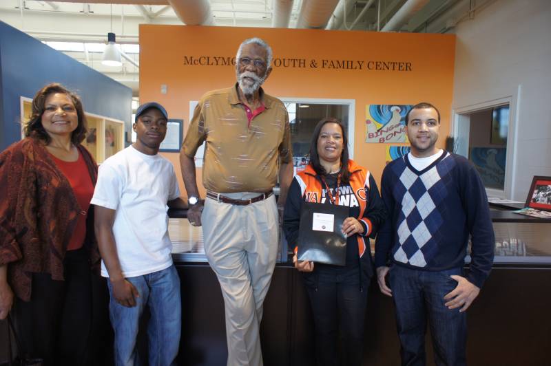 Mr. Bill Russell with a student and staff at McClymonds High School. 