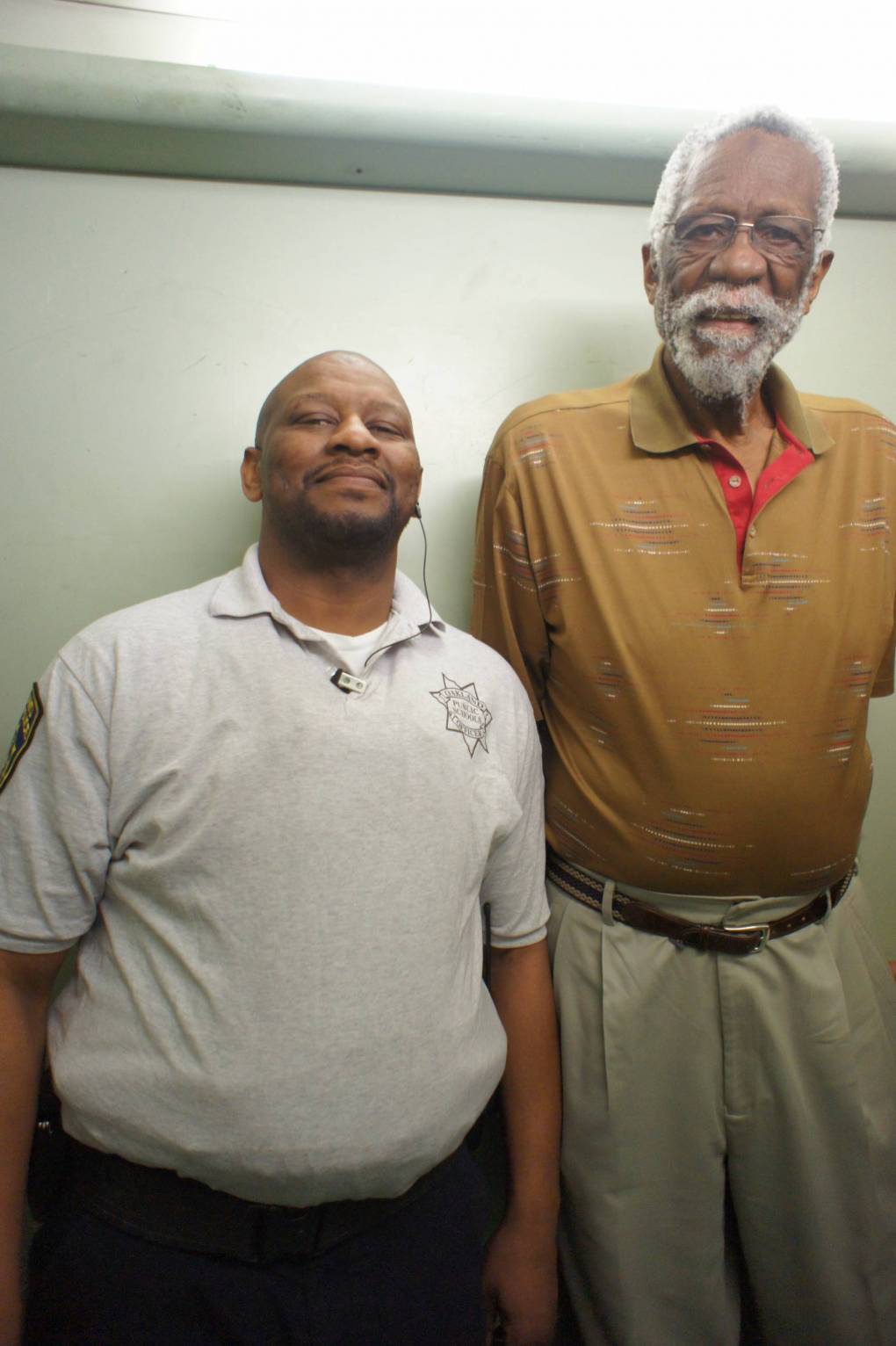 Inside of an elevator with a school security guard and Mr. Bill Russell at McClymonds High School.