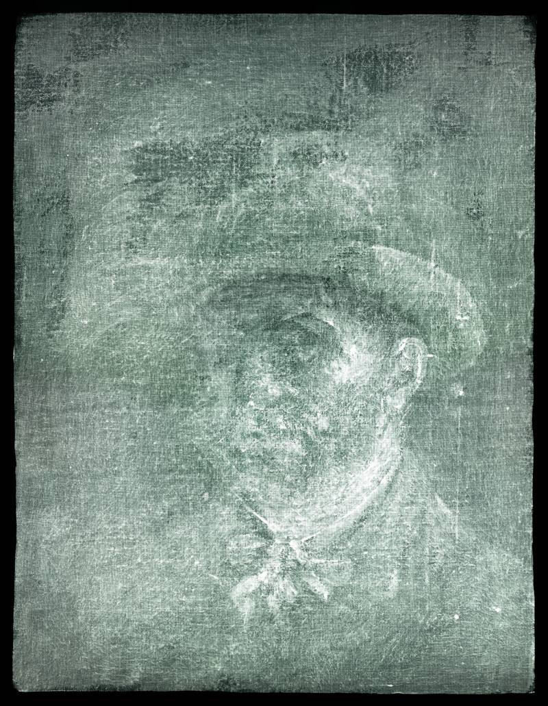 A bearded man in a brimmed hat with a neckerchief loosely tied at the throat. He fixes the viewer with an intense stare, the right side of his face in shadow and his left ear clearly visible.