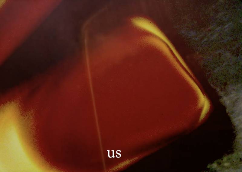 a red background with the word 'us' in white