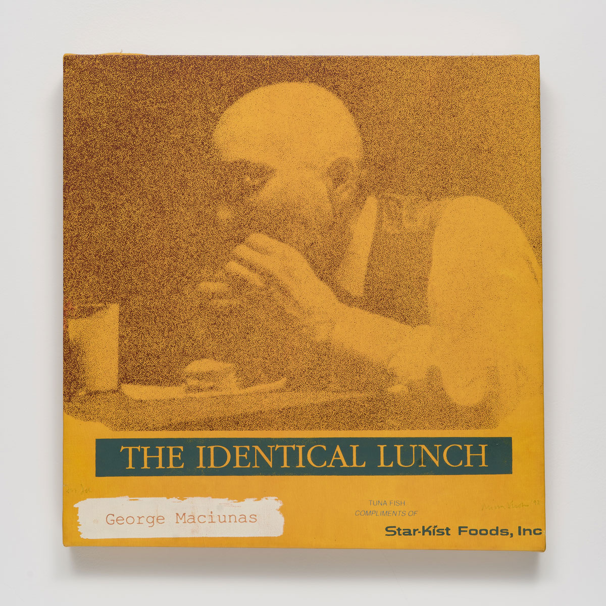 Brown on yellow print of man eating sandwich with 'the identical lunch' printed in green below