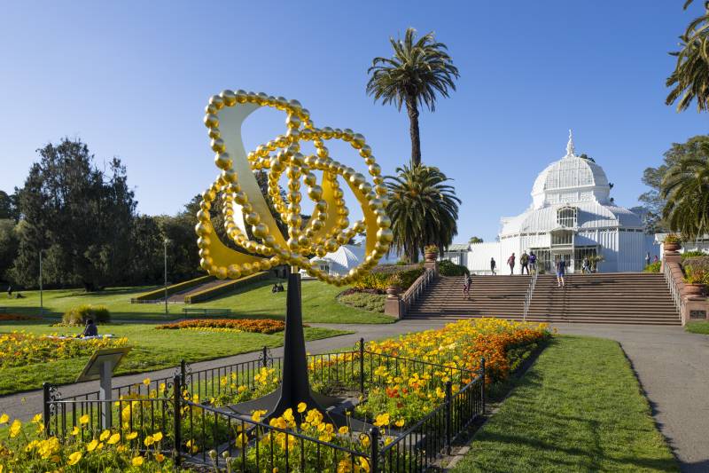 a bright gold rose sculpture in Golden Gate Park