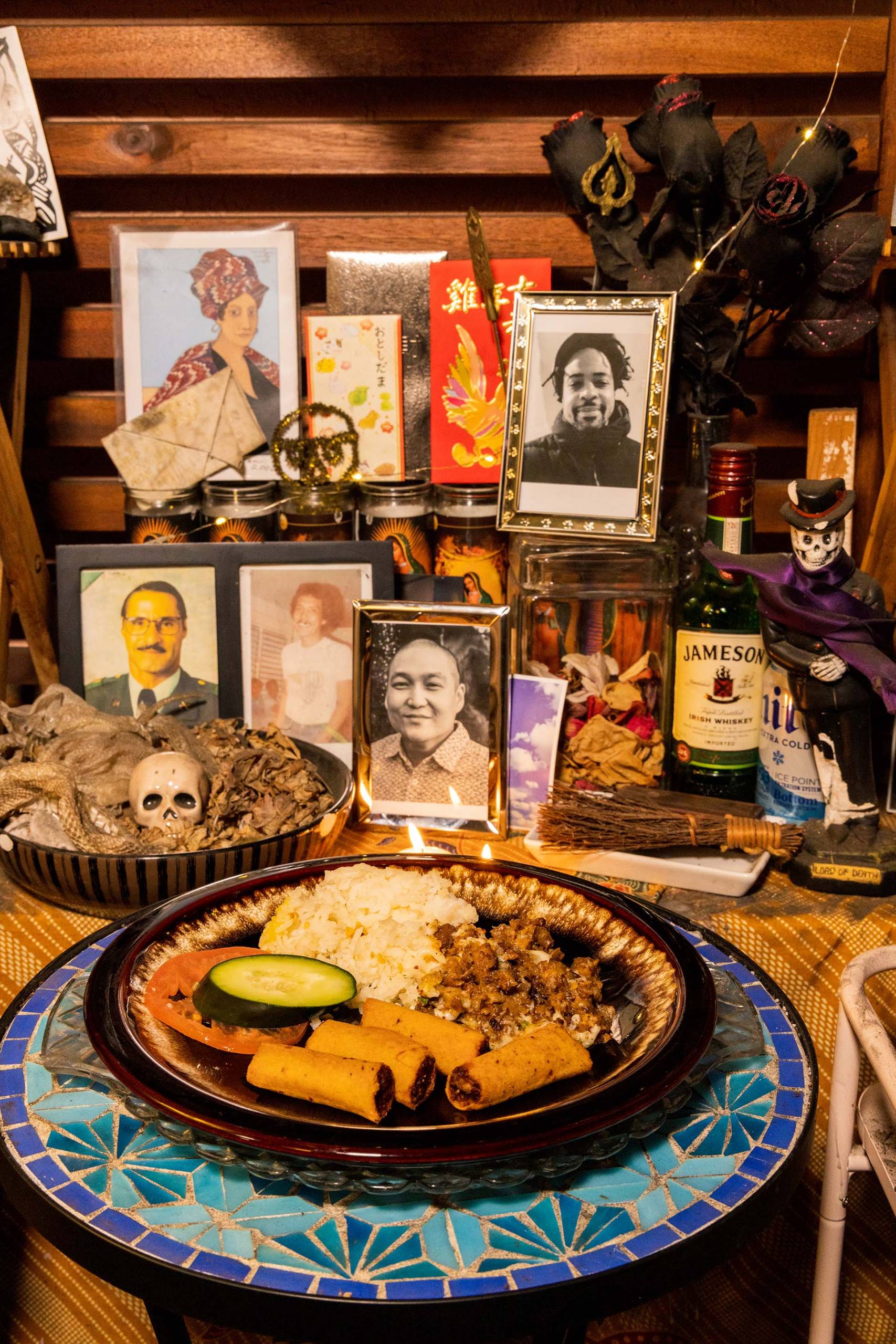 Close-up of a section of a home altar, with a plate of Filipino sisig on display as an offering to the dead.
