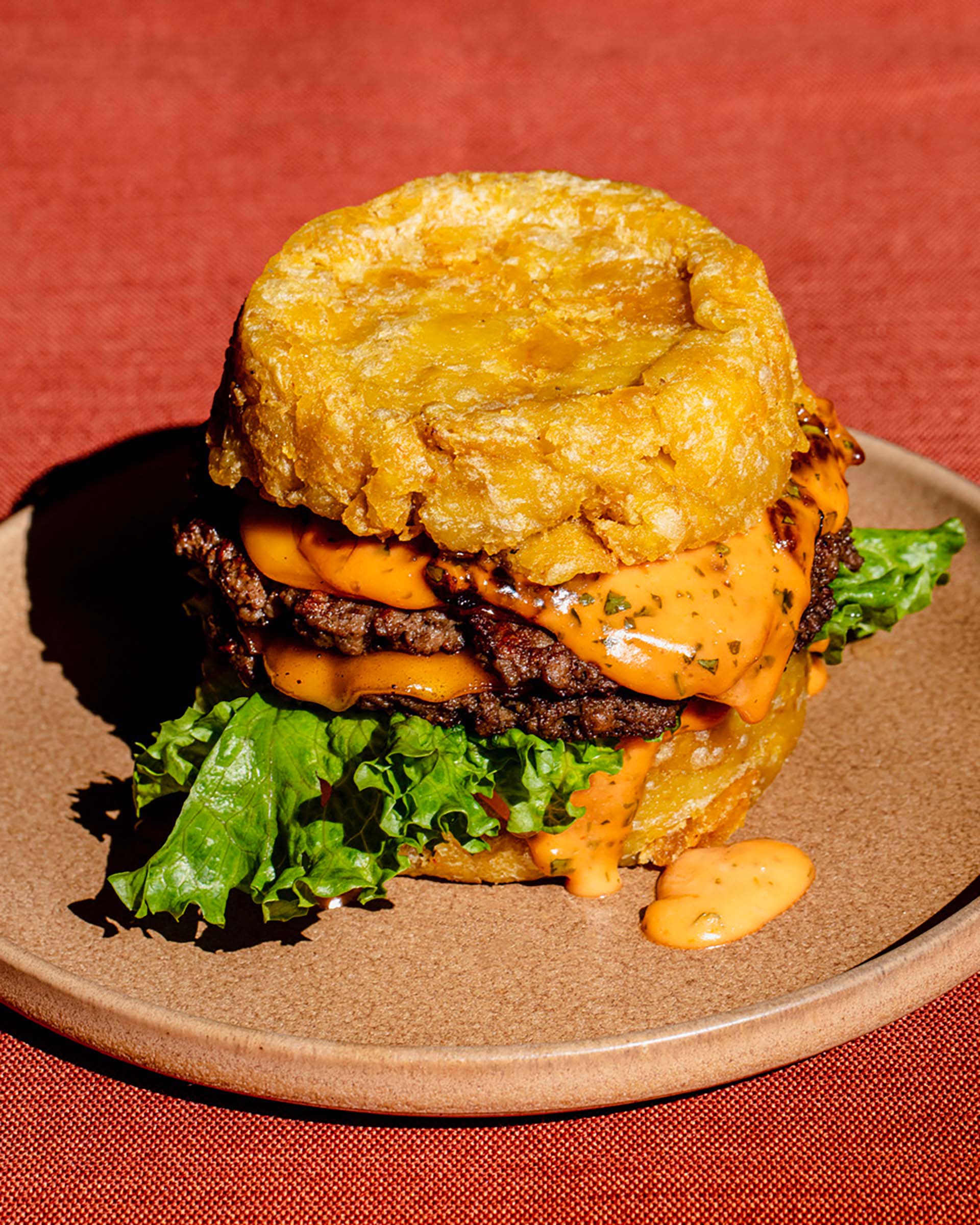 A vegan burger with mofongo (fried mashed plantains) serving as the bun.