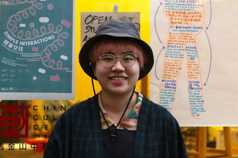 Smiling person with glasses and bucket hat