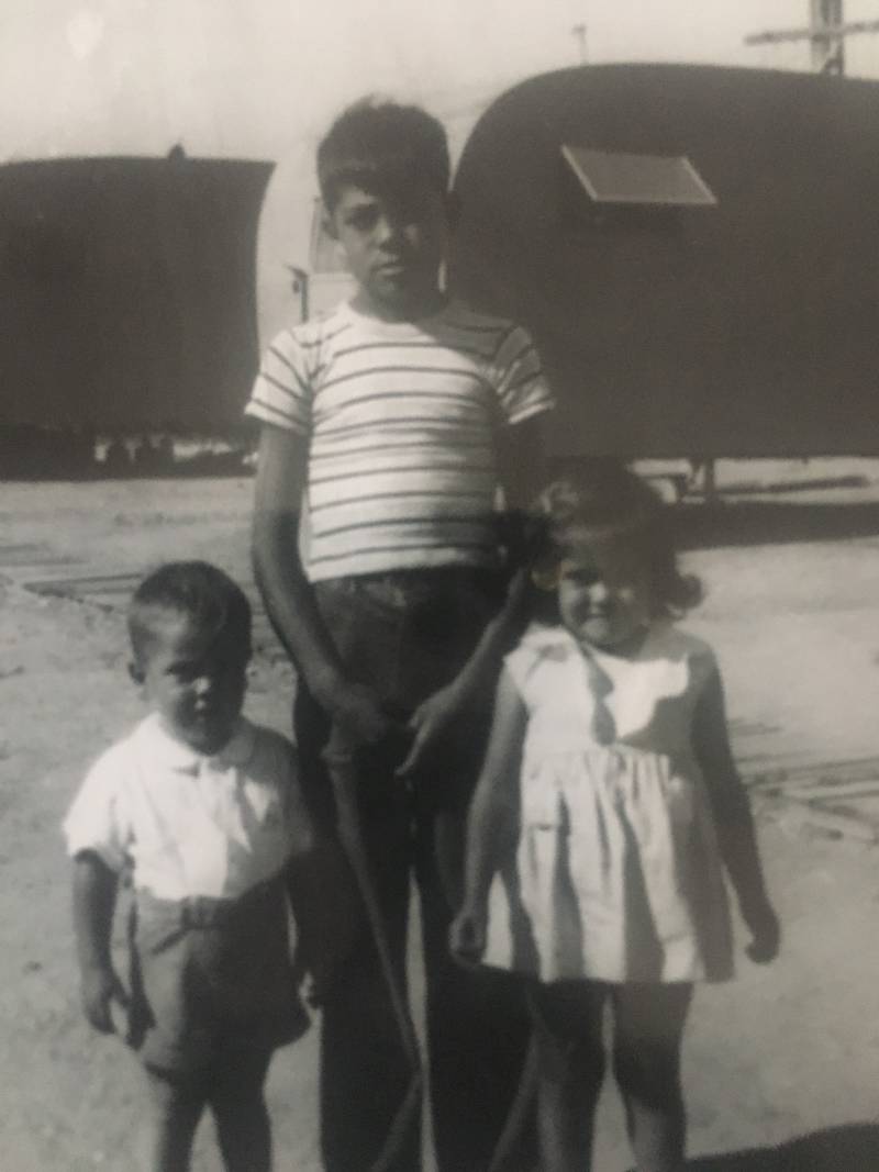 three kids in a black and white photo