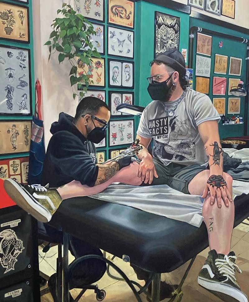 A painting that closely resembles a photo, depicting a man receiving a leg tattoo from another. They are both wearing surgical masks.