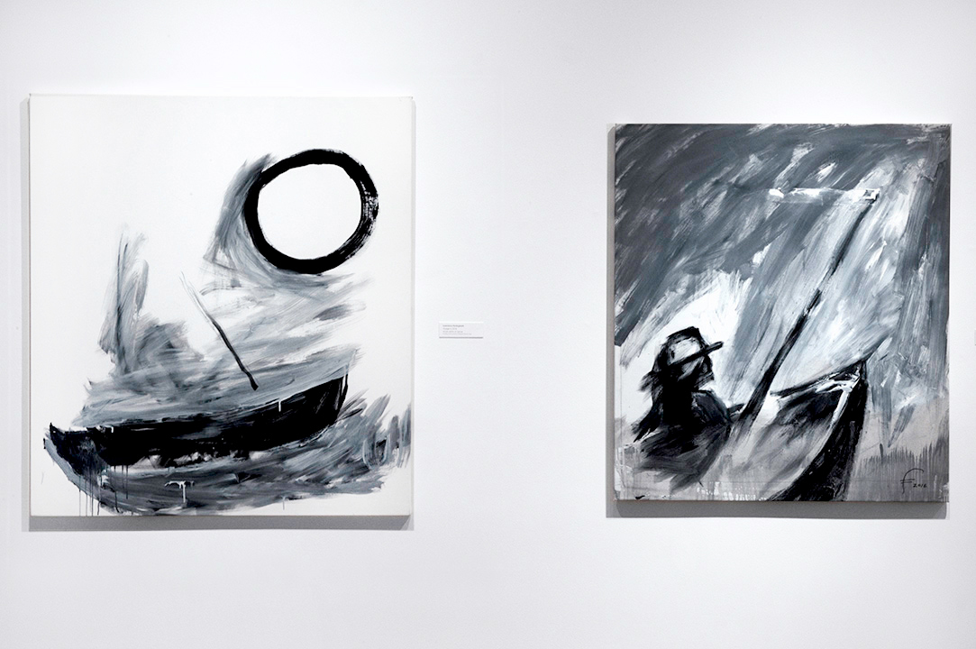 Two black-and-white paintings on white wall