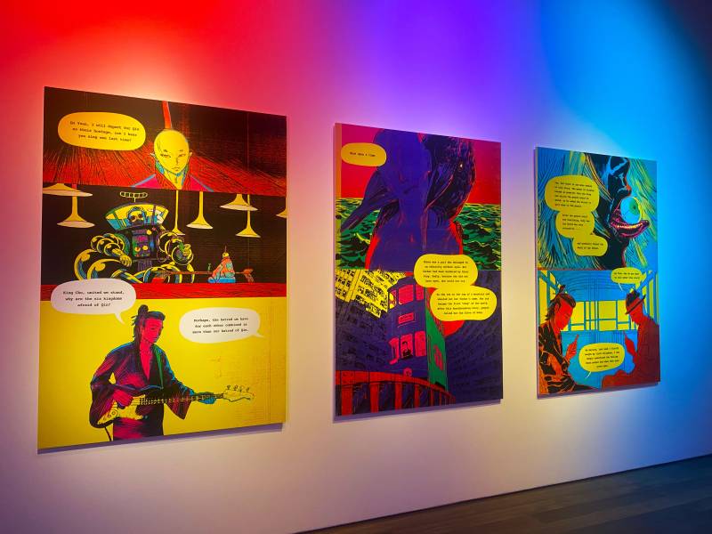 richly colored comic panels on a museum wall