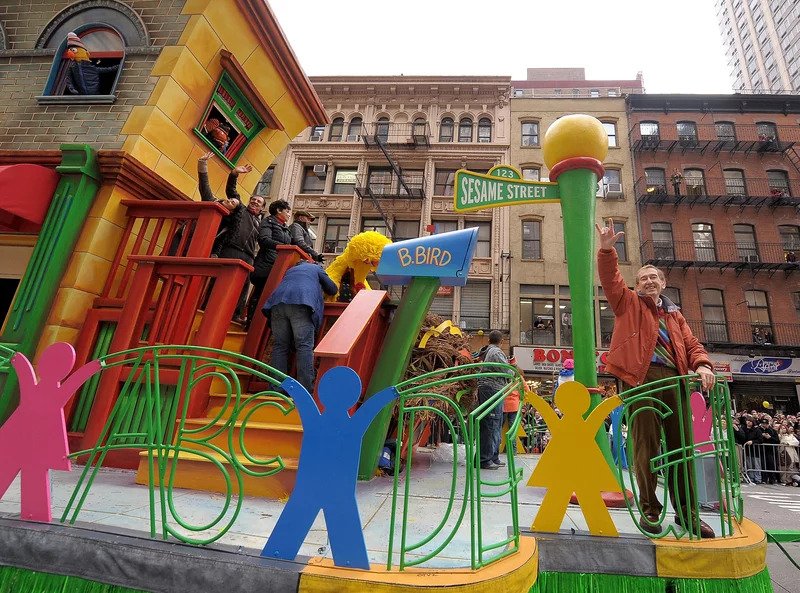 A parade float with a Sesame Street theme moves down Broadway in New York City 