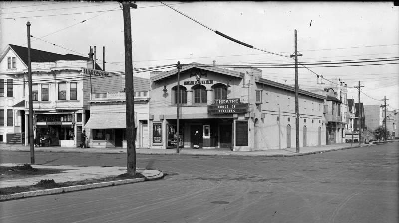 Black and white image of movie theater on street corner