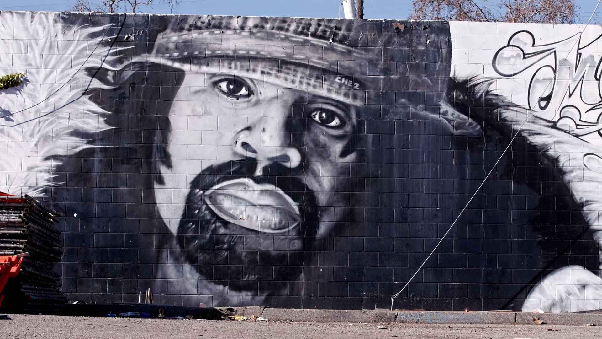 a spraypainted mural of the rap artist mac dre