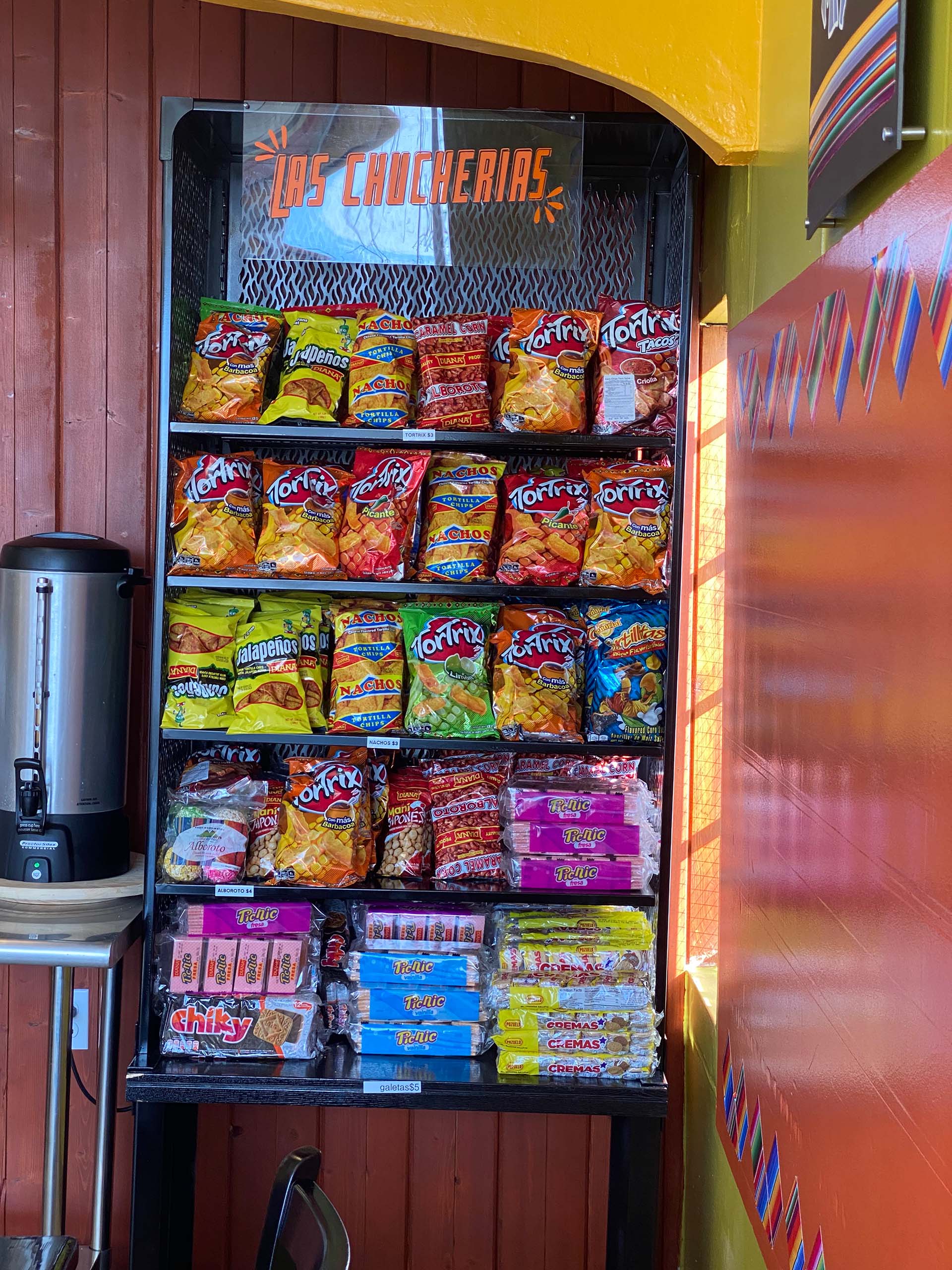 A display shelf stocked full of Central American chips and other snacks.