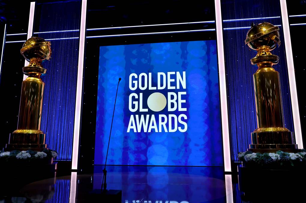 A stage with a blue backdrop reading GOLDEN GLOBE AWARDS.