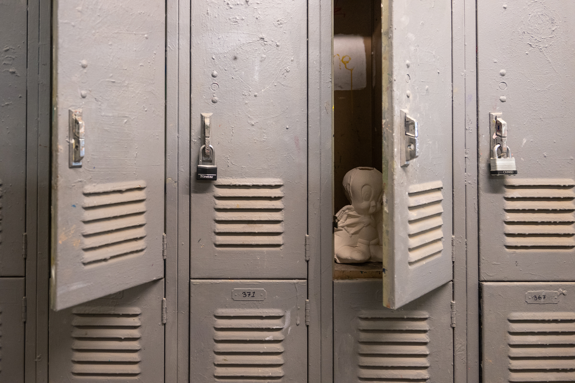 Cast plaster statue of Tweety bird sit inside ajar locker