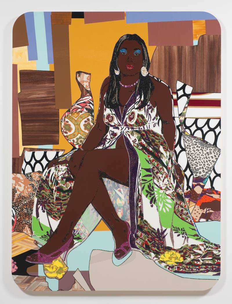 a textile work shows a Black woman dressed in colorful clothes sitting against colorful cushions