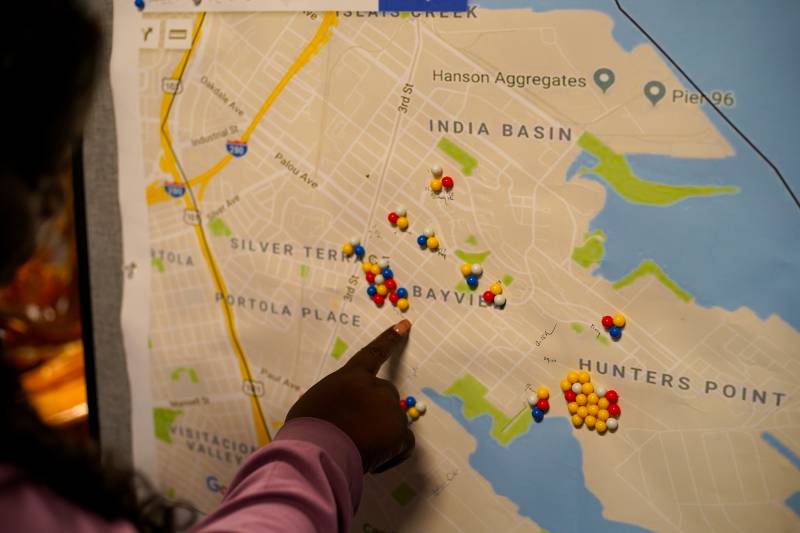 Arieann Harrison points to a map of the Bayview-Hunters Point community on the wall in her office. 