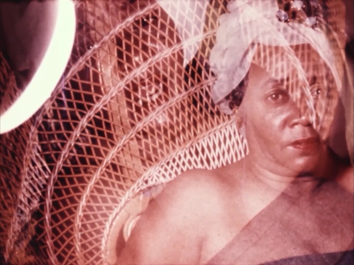 Image of Black woman in wicker chair with another transparent image of herself