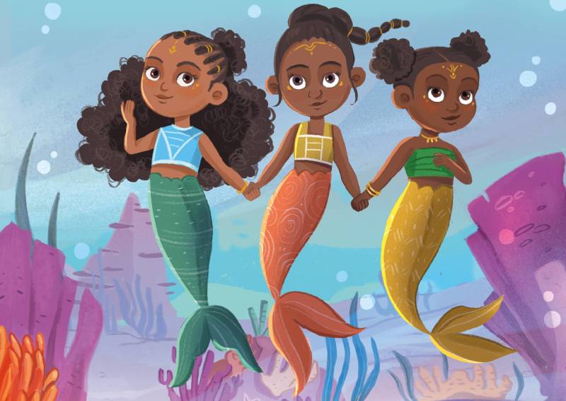 A colorful illustration of three Black mermaids holding hands and floating in the ocean.