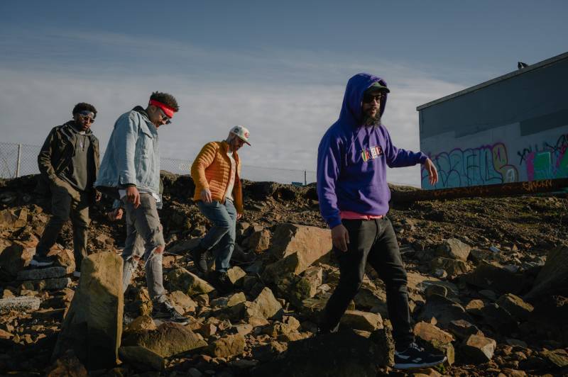 A group of local rappers wanders along the coast of the San Pablo Bay