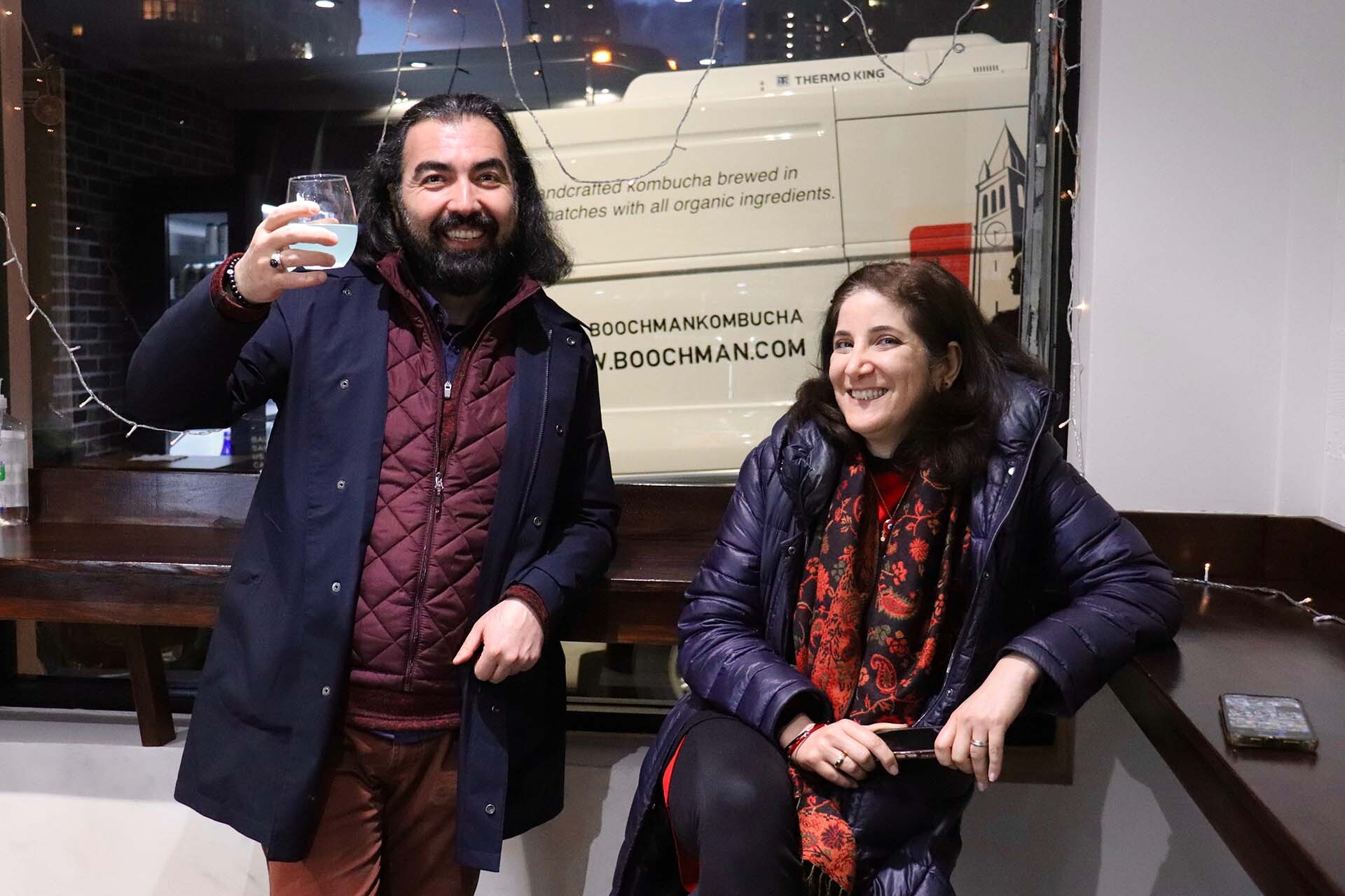 two Turkish customers celebrating kombucha and food in San Francisco
