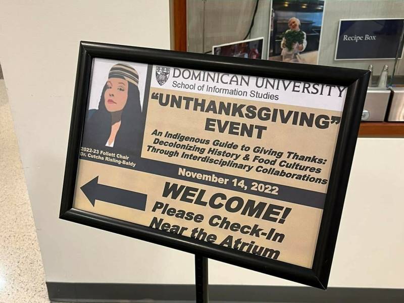 A poster for an "Unthanksgiving event" welcomes visitors in a hallway.