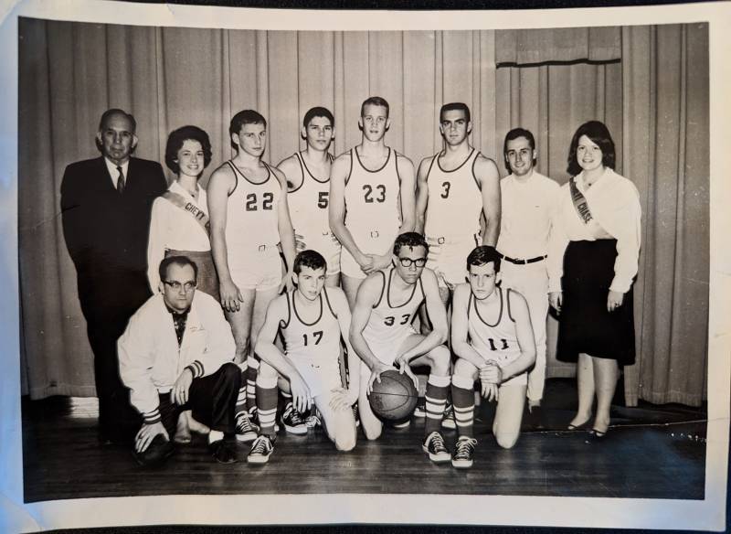 a black and white photo shows a high school basketball team from the 1960s